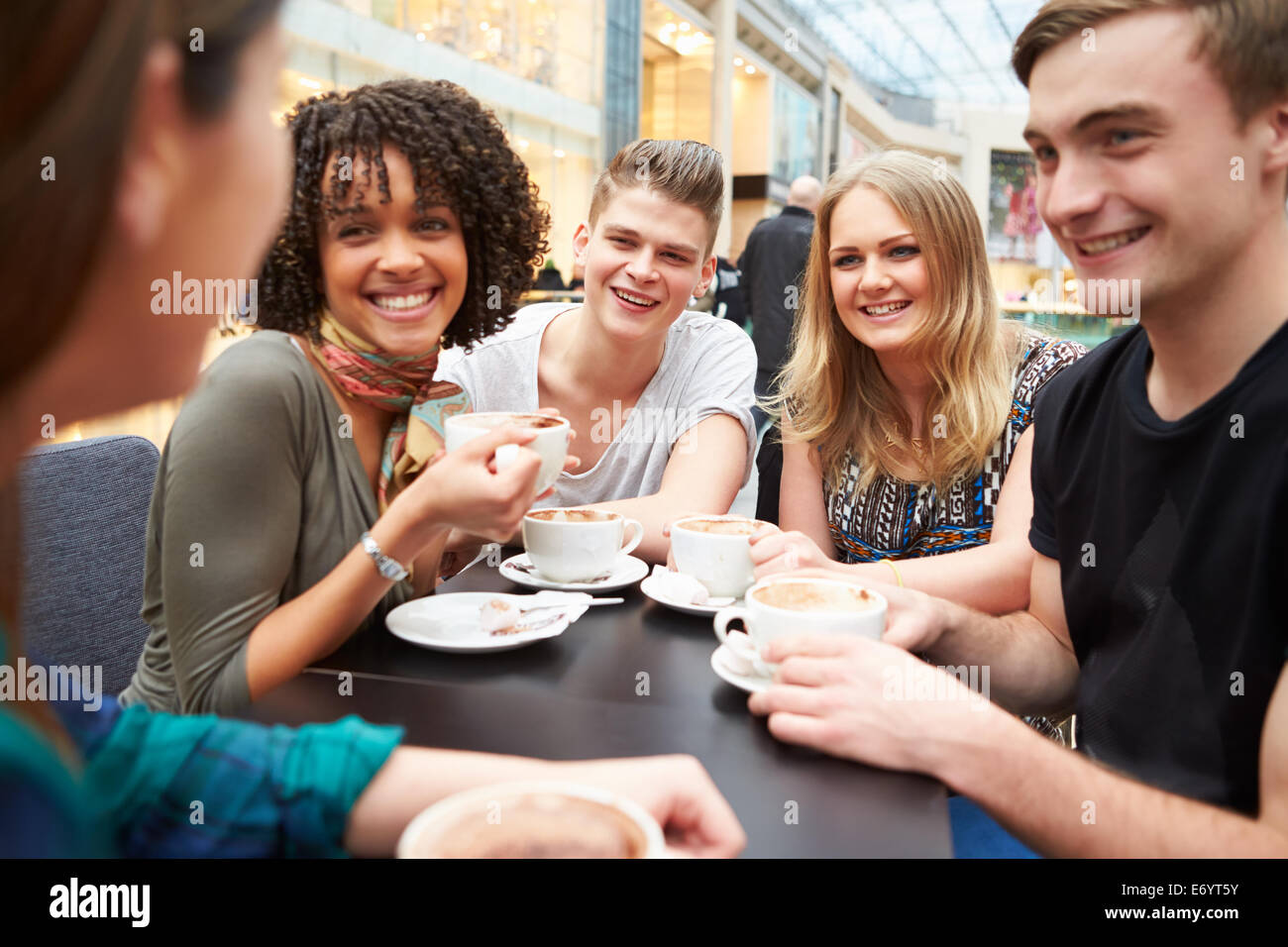 Group Of Young Friends Meeting In Café Stock Photo