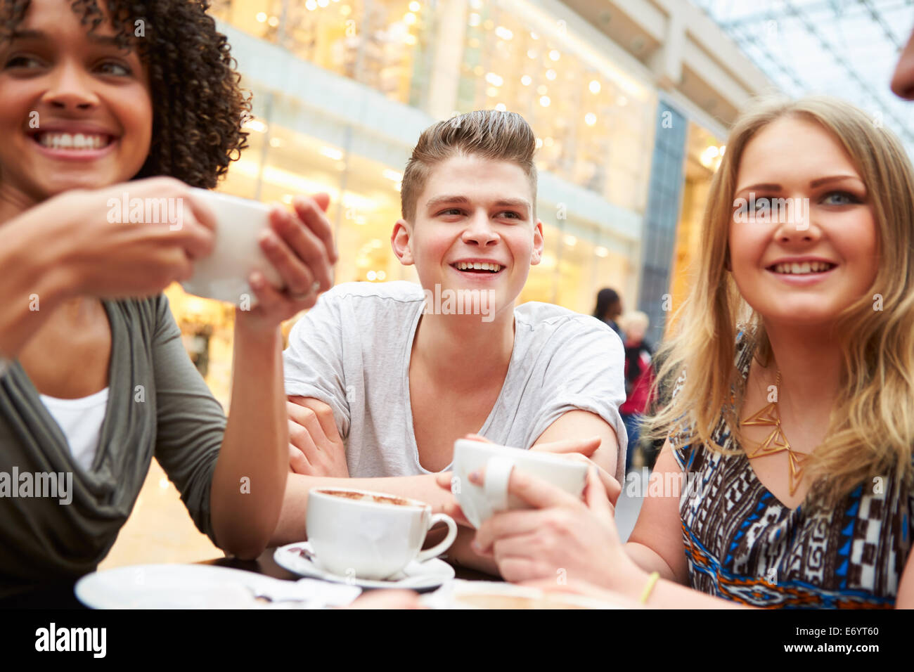 Group Of Young Friends Meeting In Café Stock Photo