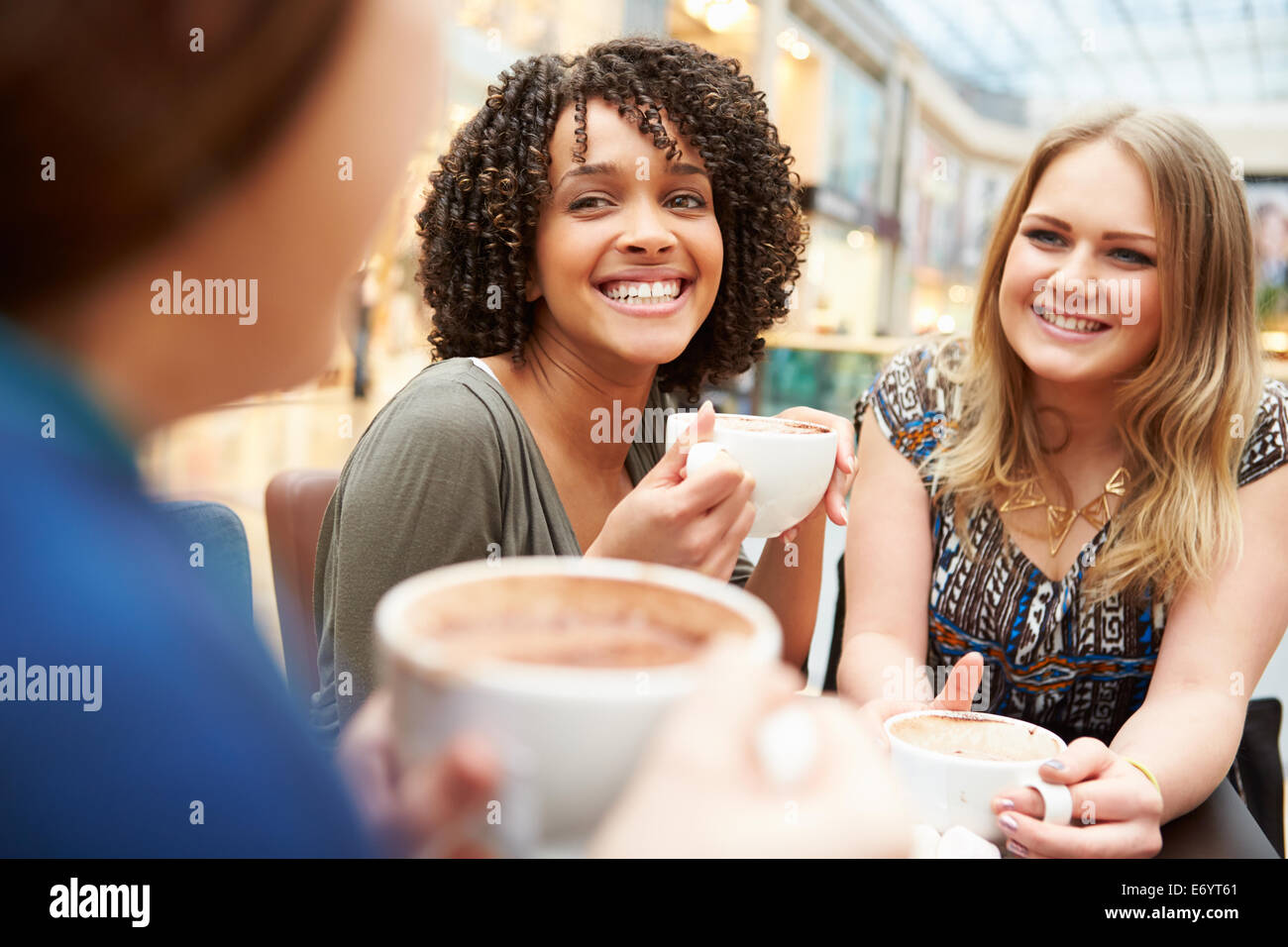 Group Of Young Female Friends Meeting In Café Stock Photo