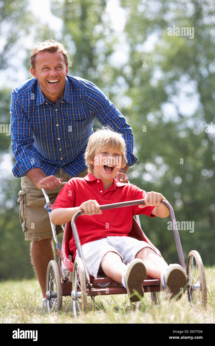 Father and son playing with go-kart Stock Photo
