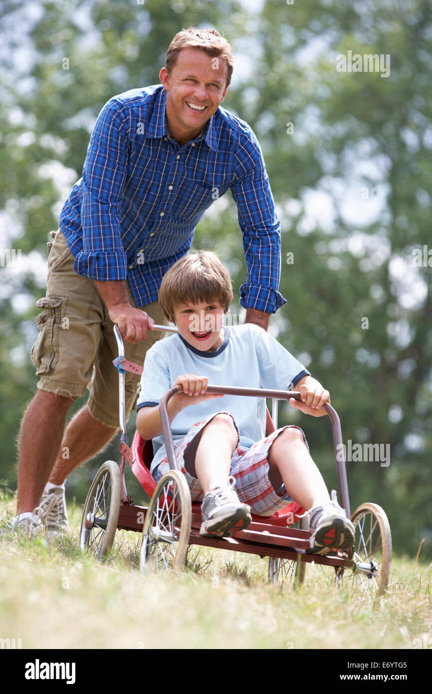 Father and son playing with go-kart Stock Photo