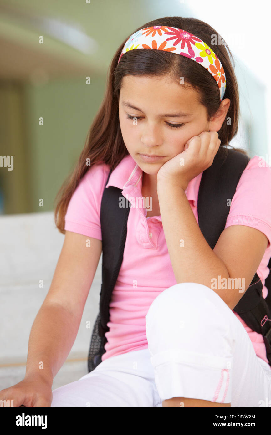 Unhappy Pre teen girl at school Stock Photo