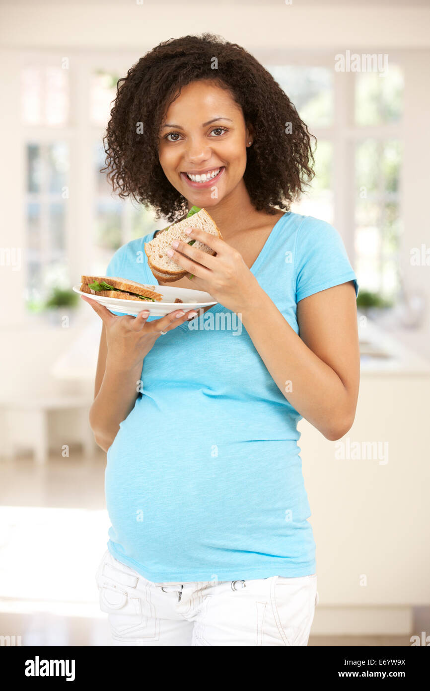 Pregnant woman eating sandwich Stock Photo Alamy