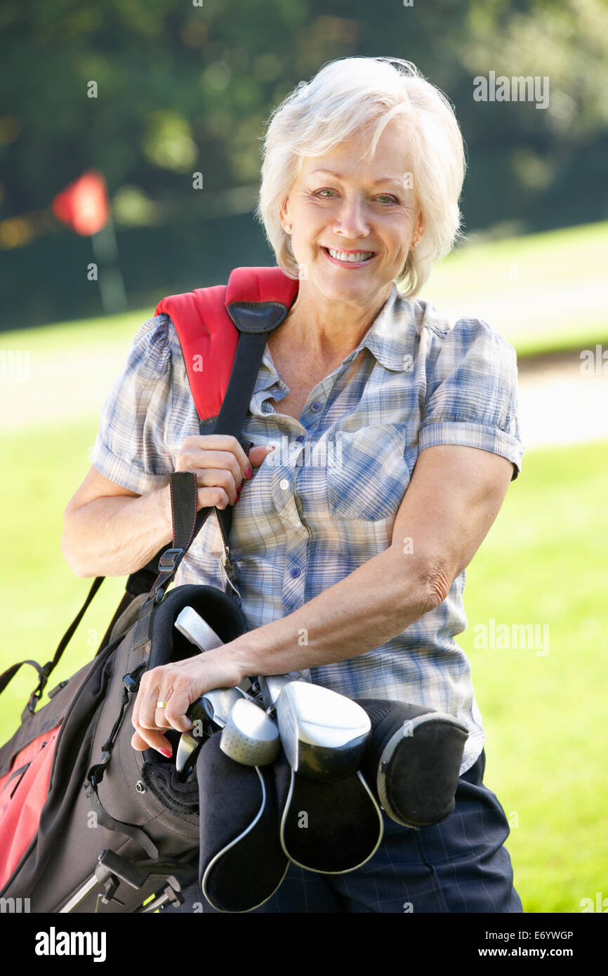 Senior woman on golf course Stock Photo