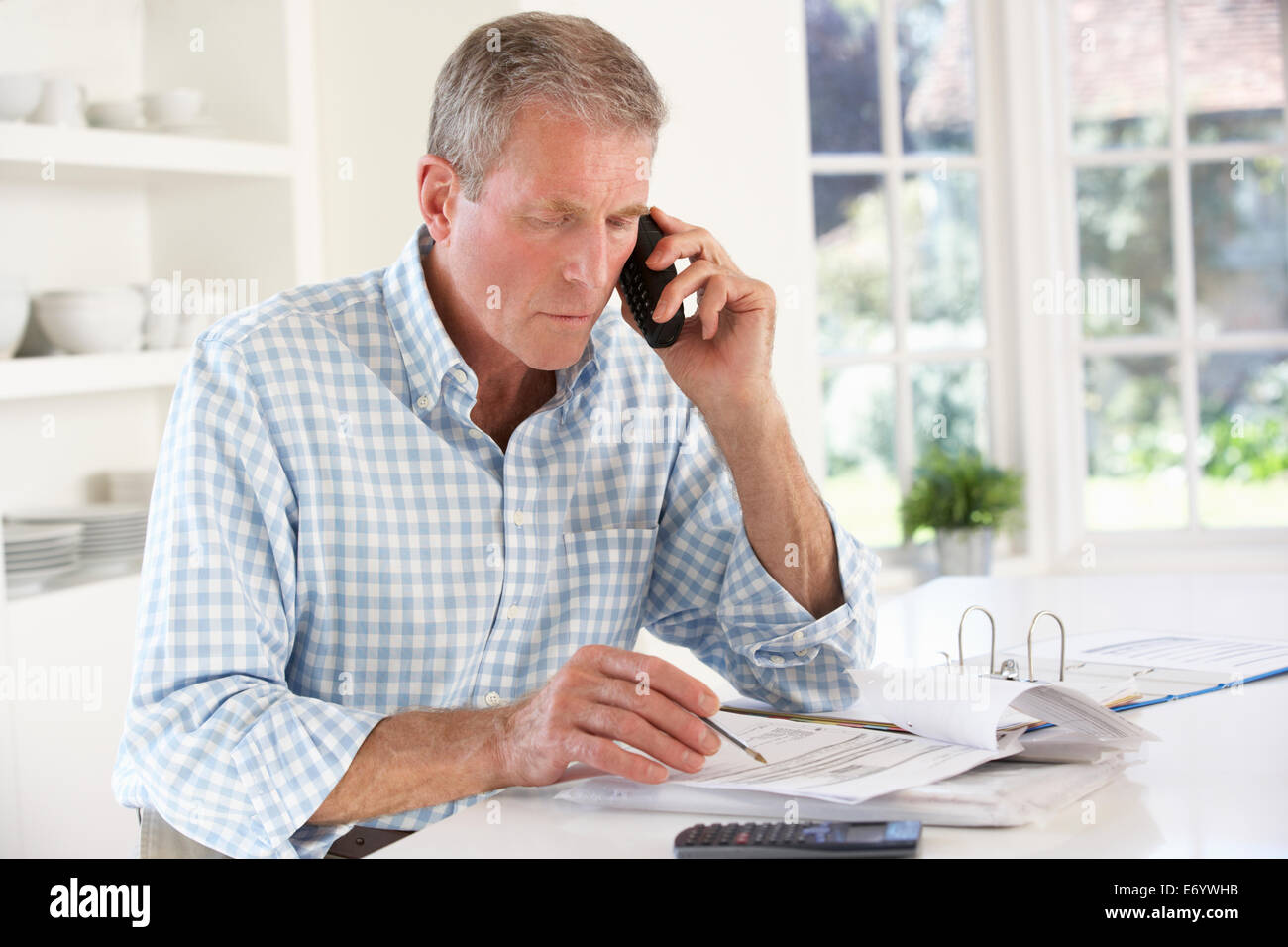 Retired man with household bills Stock Photo