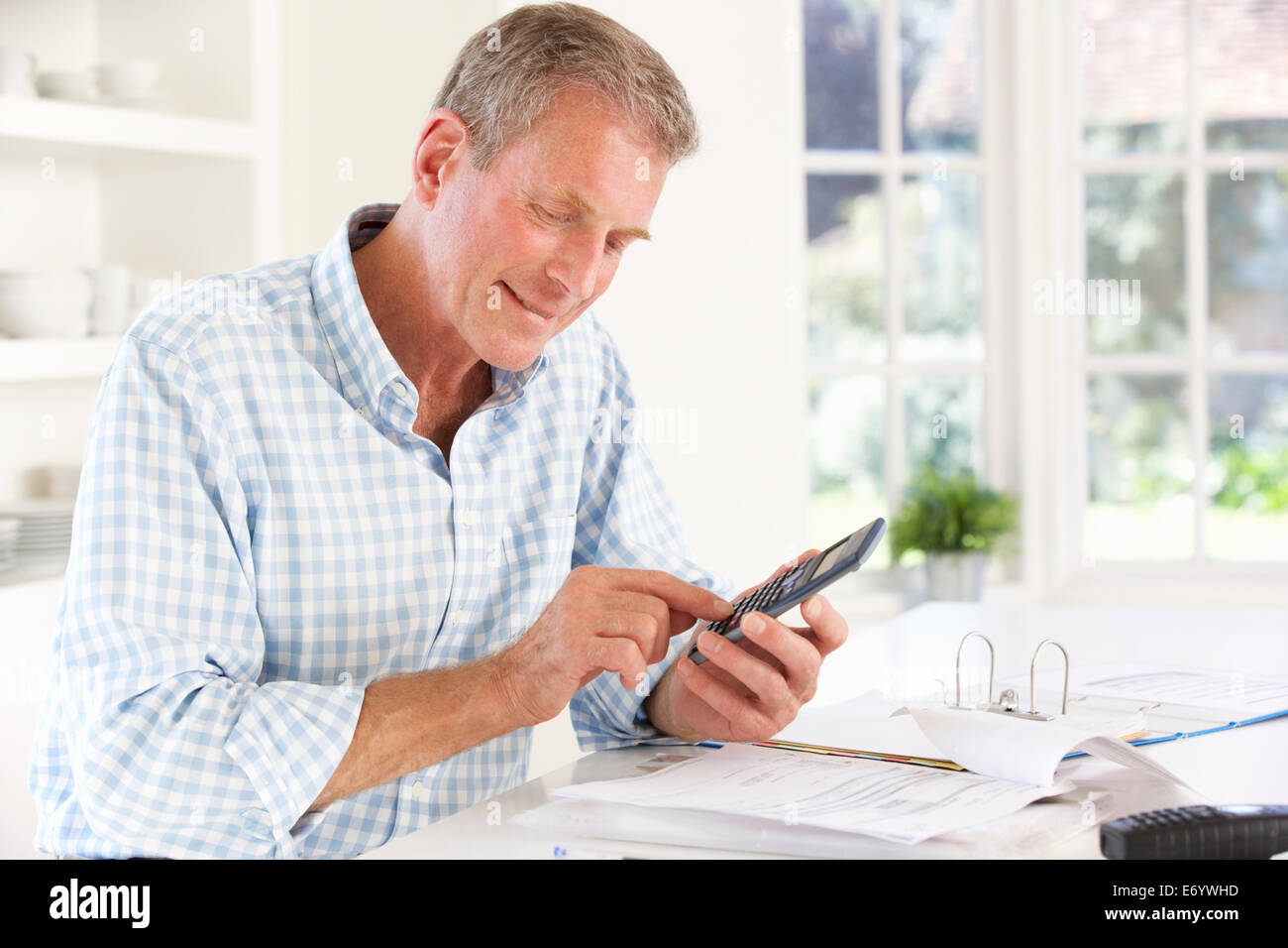 Retired man with household bills Stock Photo