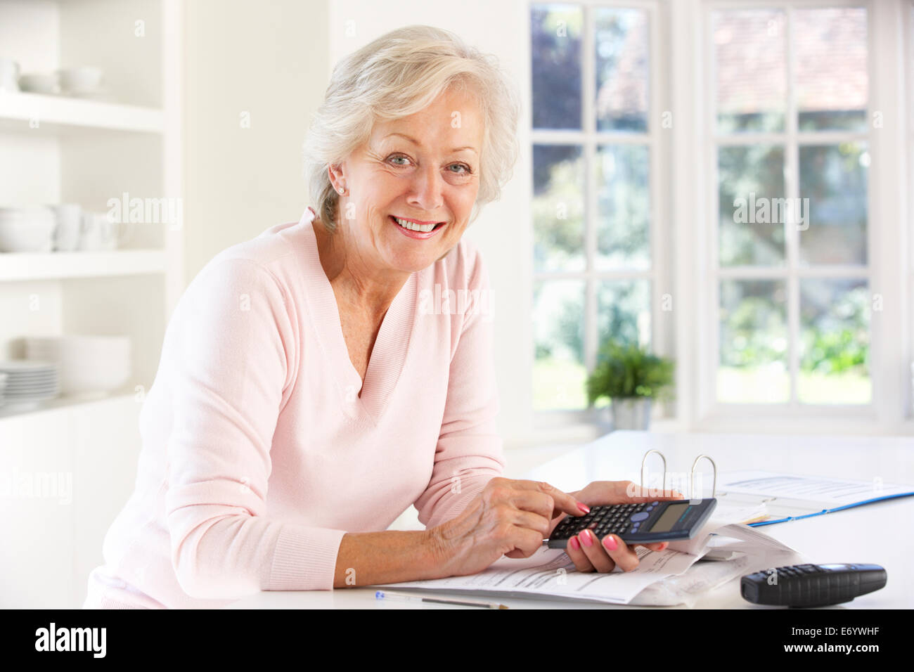 Retired woman with household bills Stock Photo