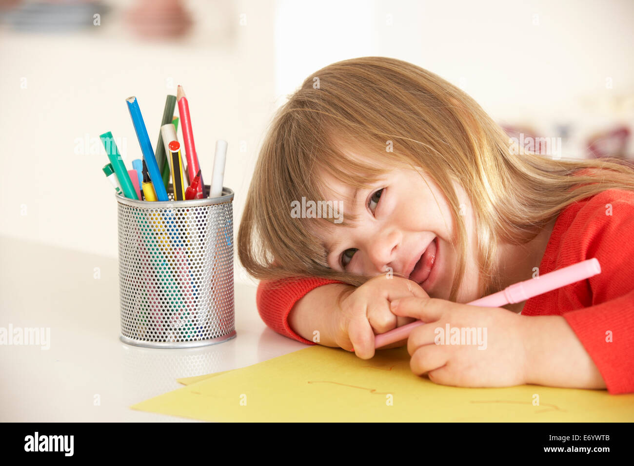 Girl with Downs Syndrome drawing Stock Photo