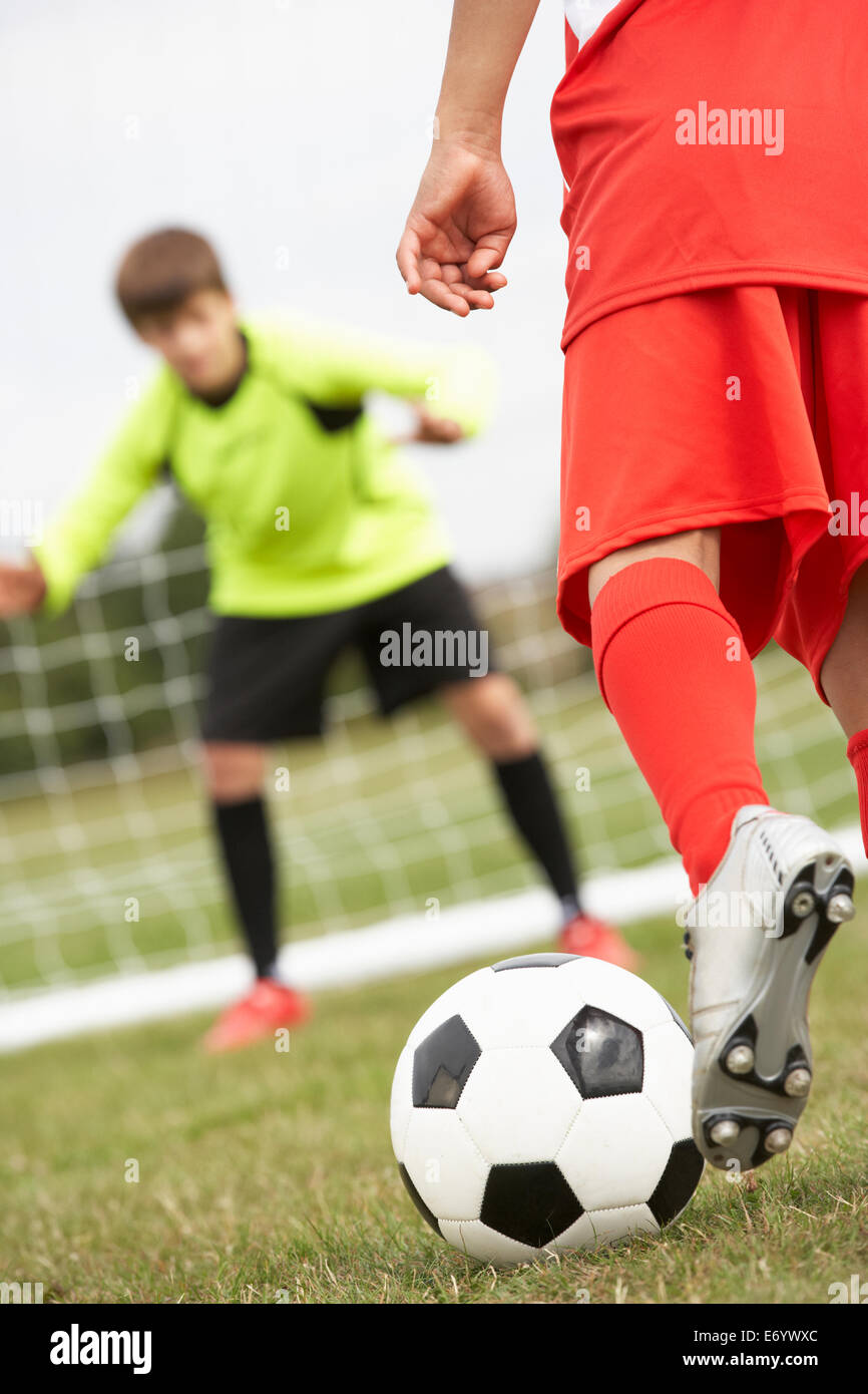 Boy goalkeeper braced for penalty shot Stock Photo