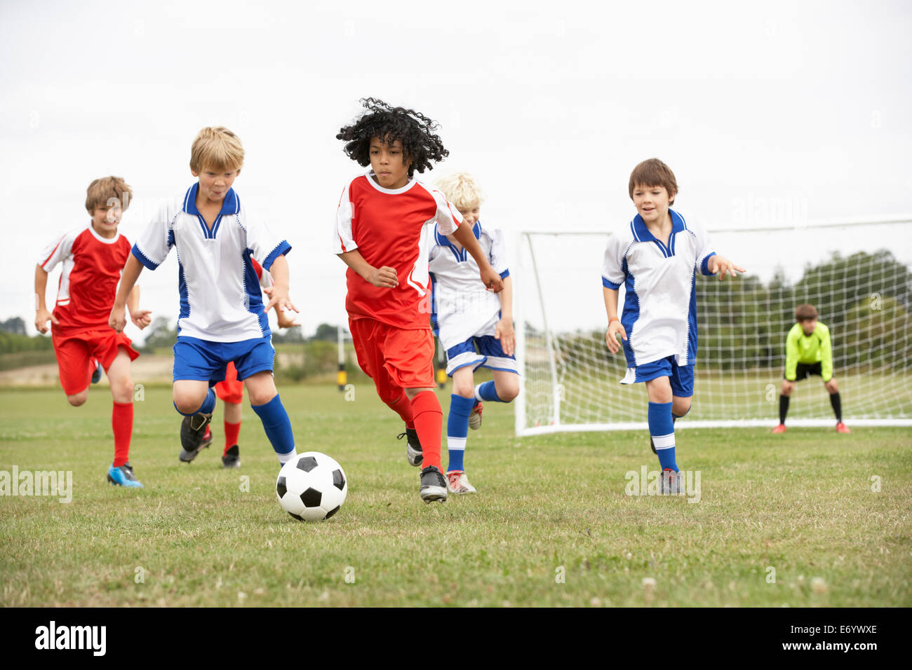 Junior 5 a side teams playing football Stock Photo