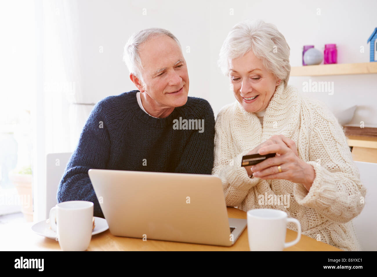 Senior Couple Using Laptop To Shop Online Stock Photo