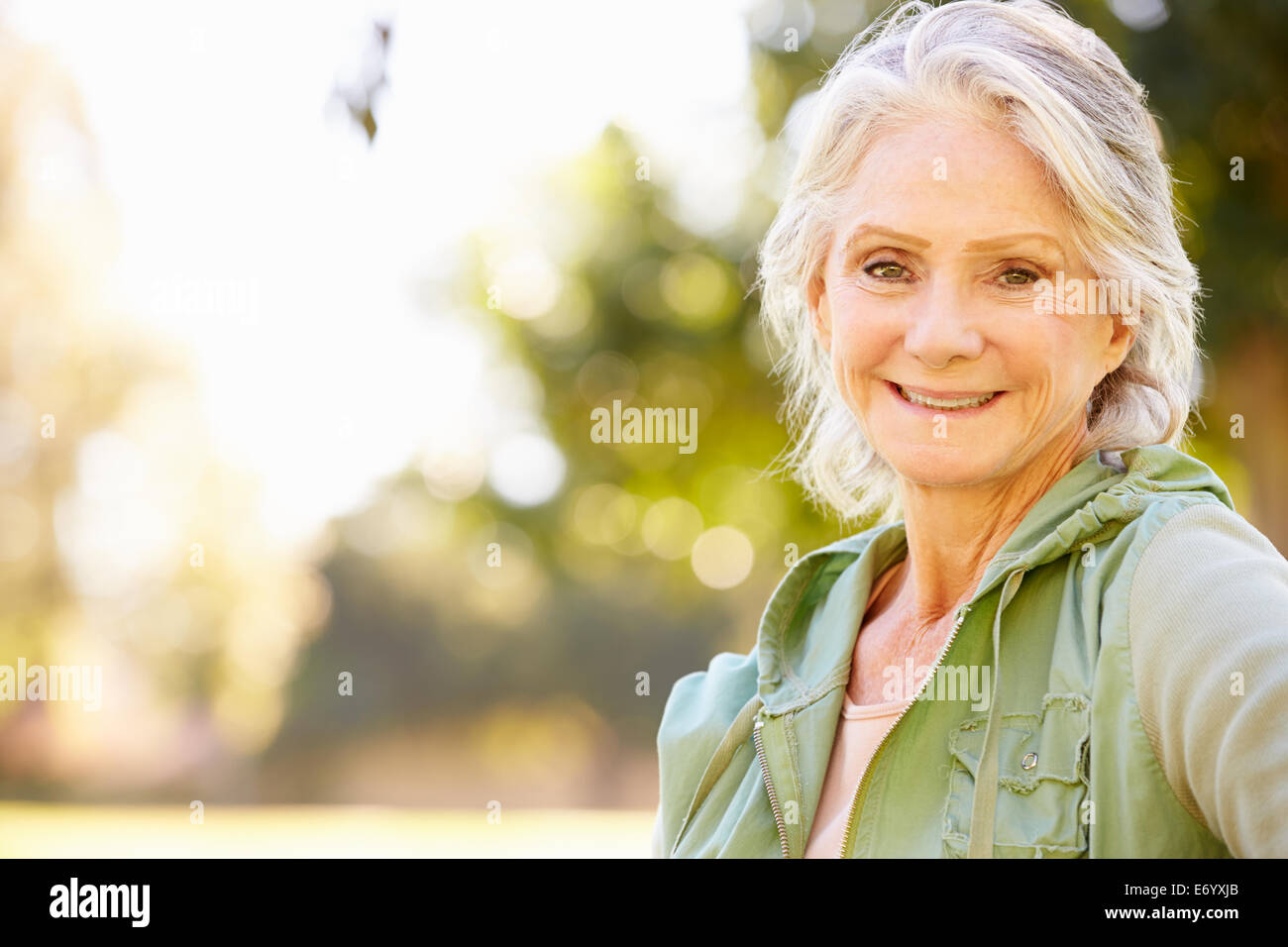 Outdoor Portrait Of Smiling Senior Woman Stock Photo