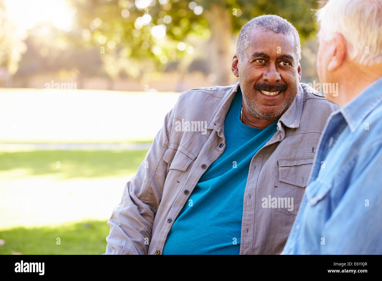 Two Senior Men Talking Outdoors Together Stock Photo