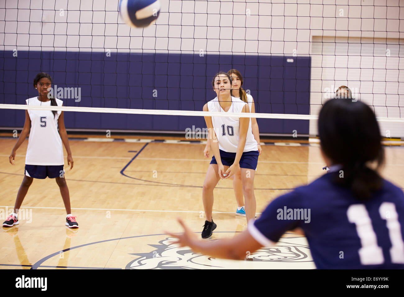 High School Volleyball Match In Gymnasium Stock Photo