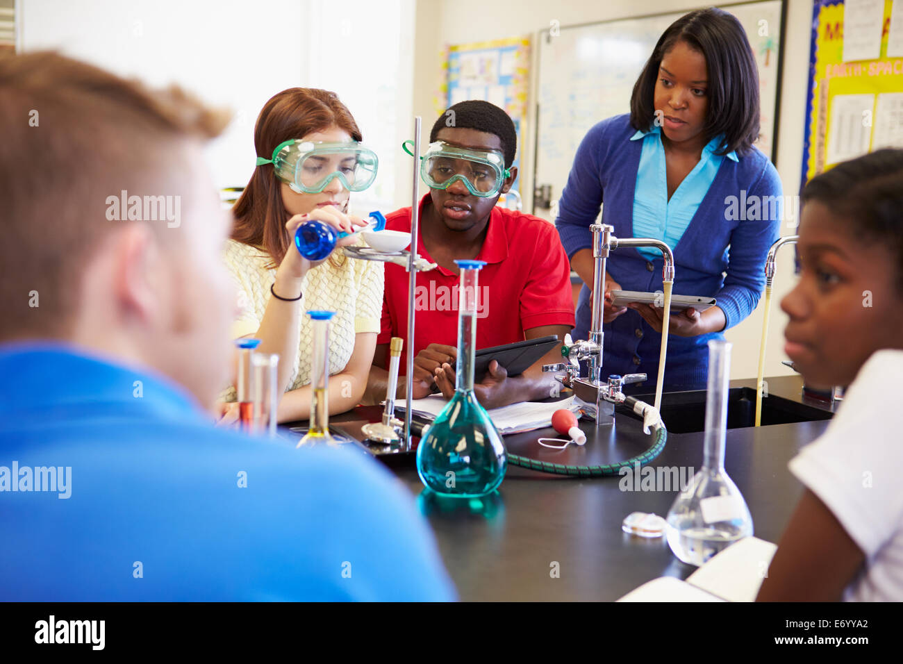 Pupils Carrying Out Experiment In Science Class Stock Photo