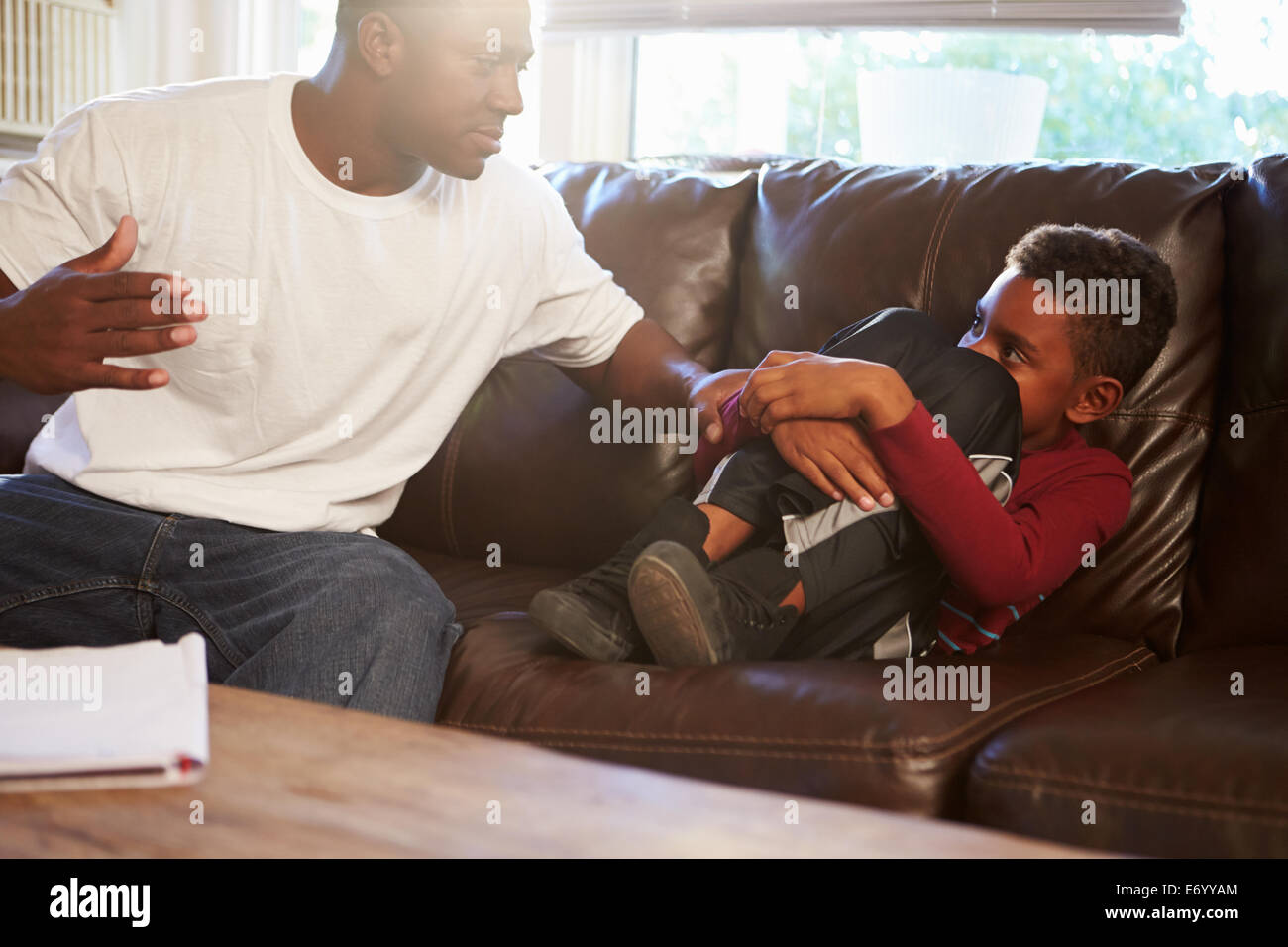 Father Being Physically Abusive Towards Son At Home Stock Photo