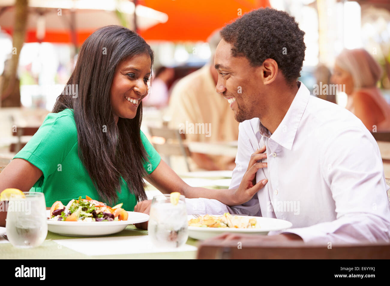 Couple Enjoying Lunch In Outdoor Restaurant Stock Photo