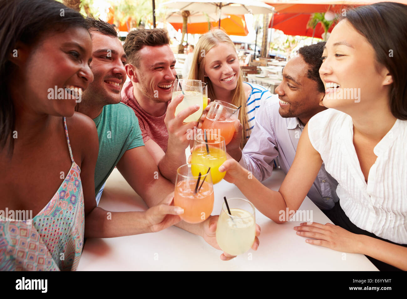 Group Of Friends Enjoying Drinks In Outdoor Restaurant Stock Photo