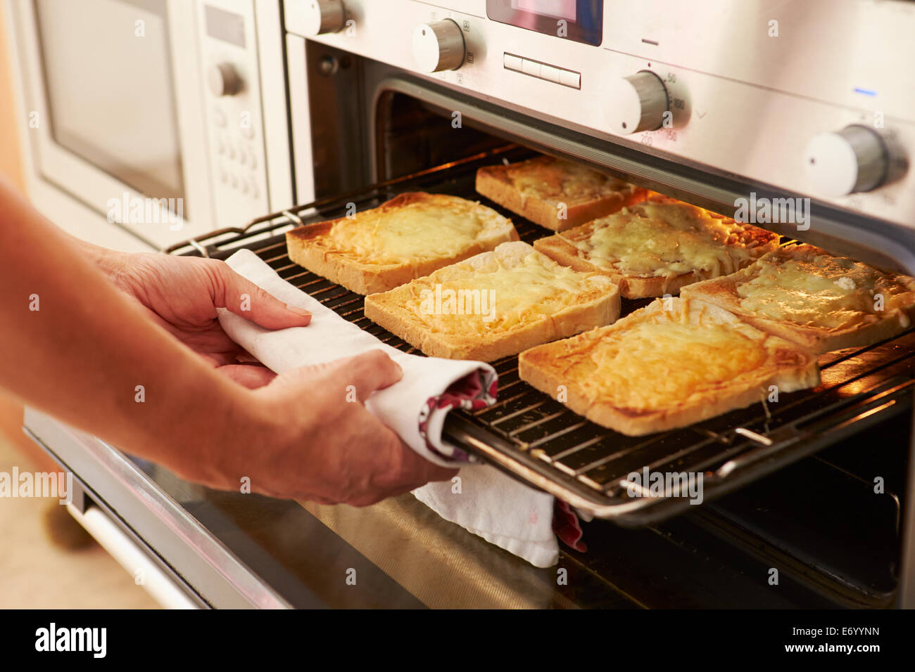 Cheese On Toast Being Grilled In Oven Stock Photo