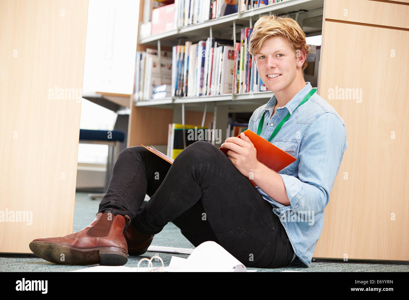 Male College Student Studying In Library Stock Photo