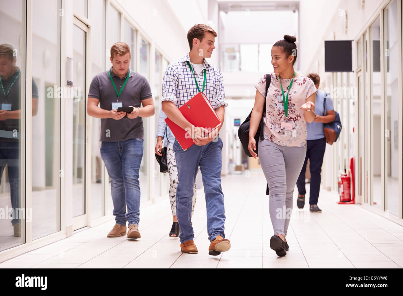 Group Of College Students Walking Along Corridor Stock Photo