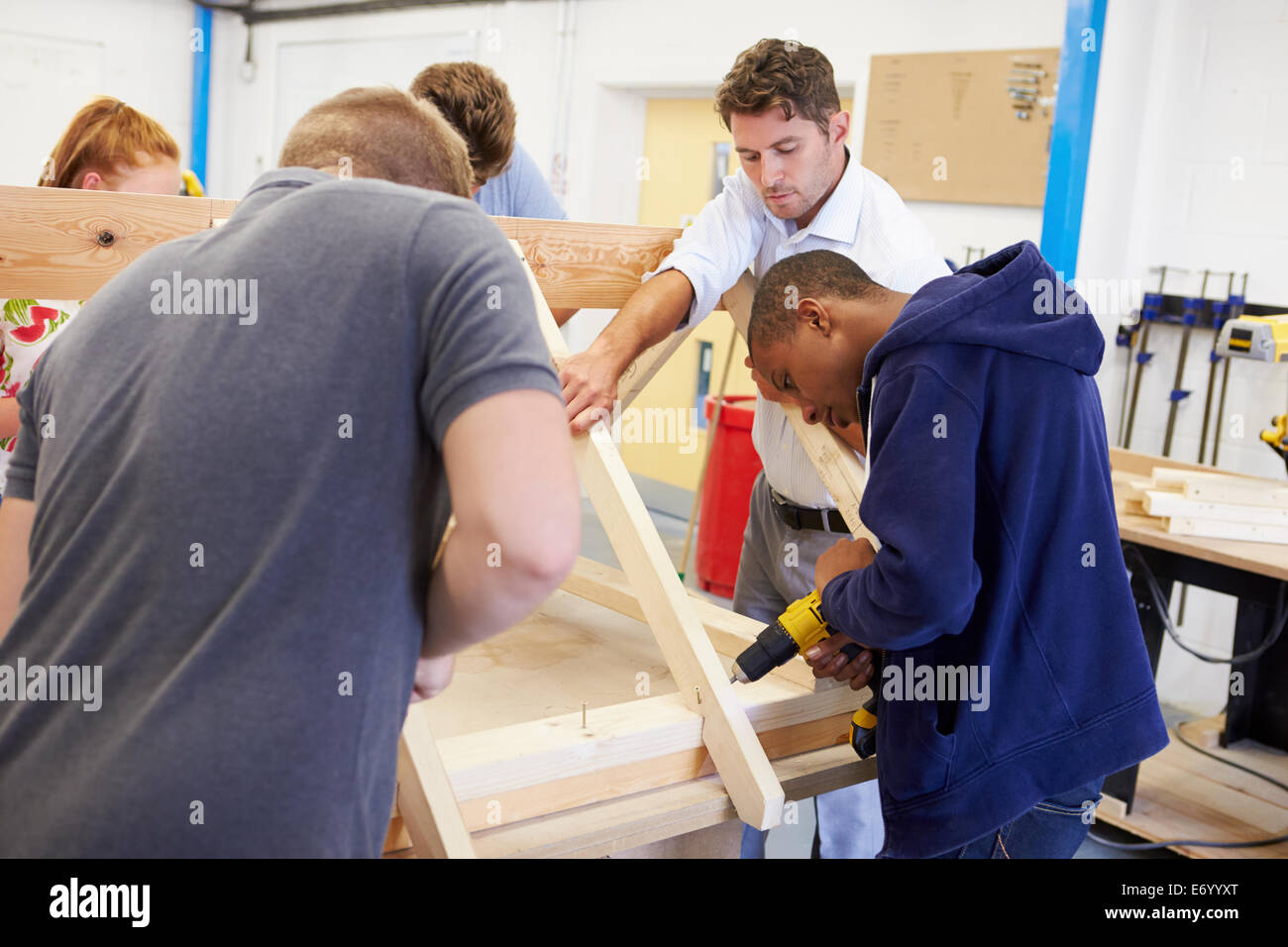 Teacher Helping College Students Studying Carpentry Stock Photo