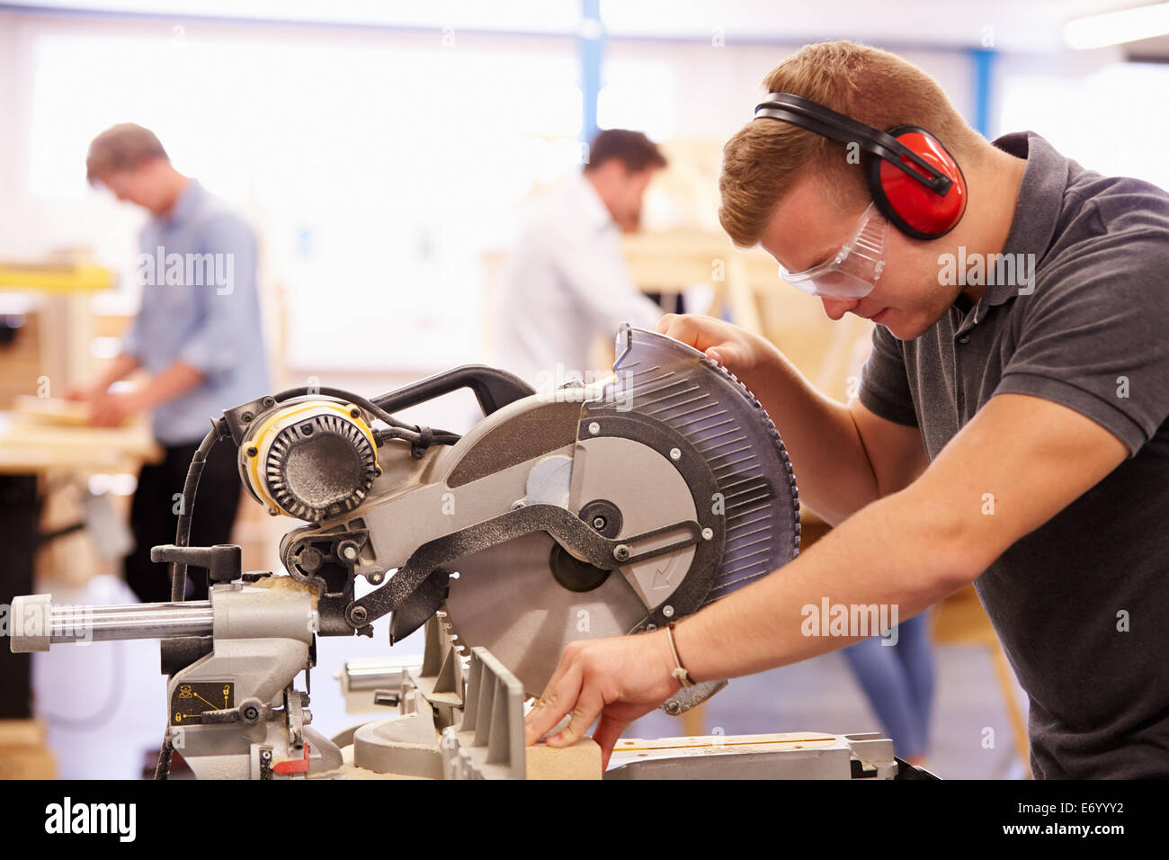 Student In Carpentry Class Using Circular Saw Stock Photo