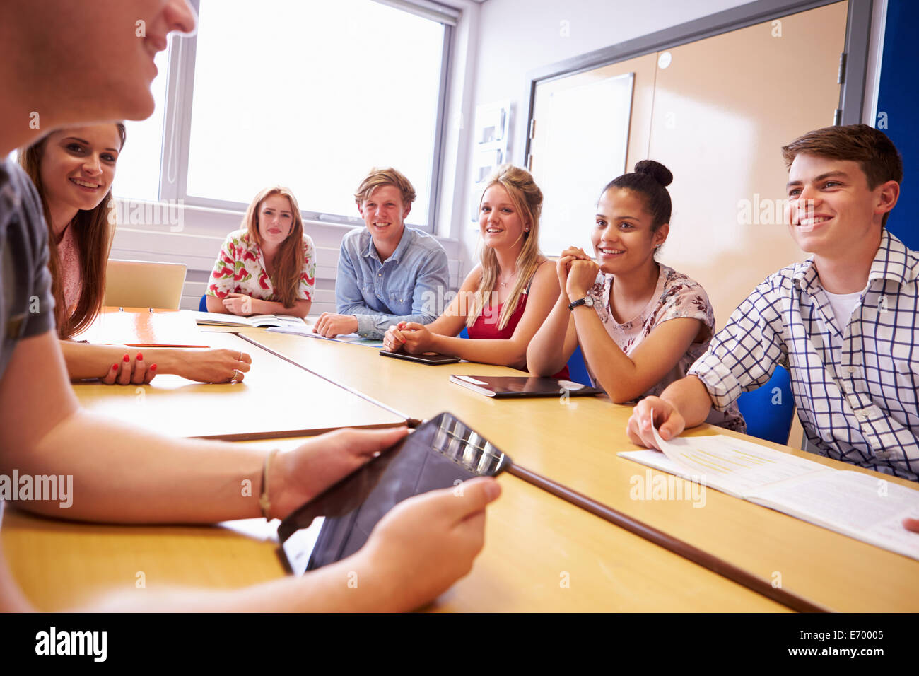 Group Of College Students Sitting At Table Having Discussion Stock Photo