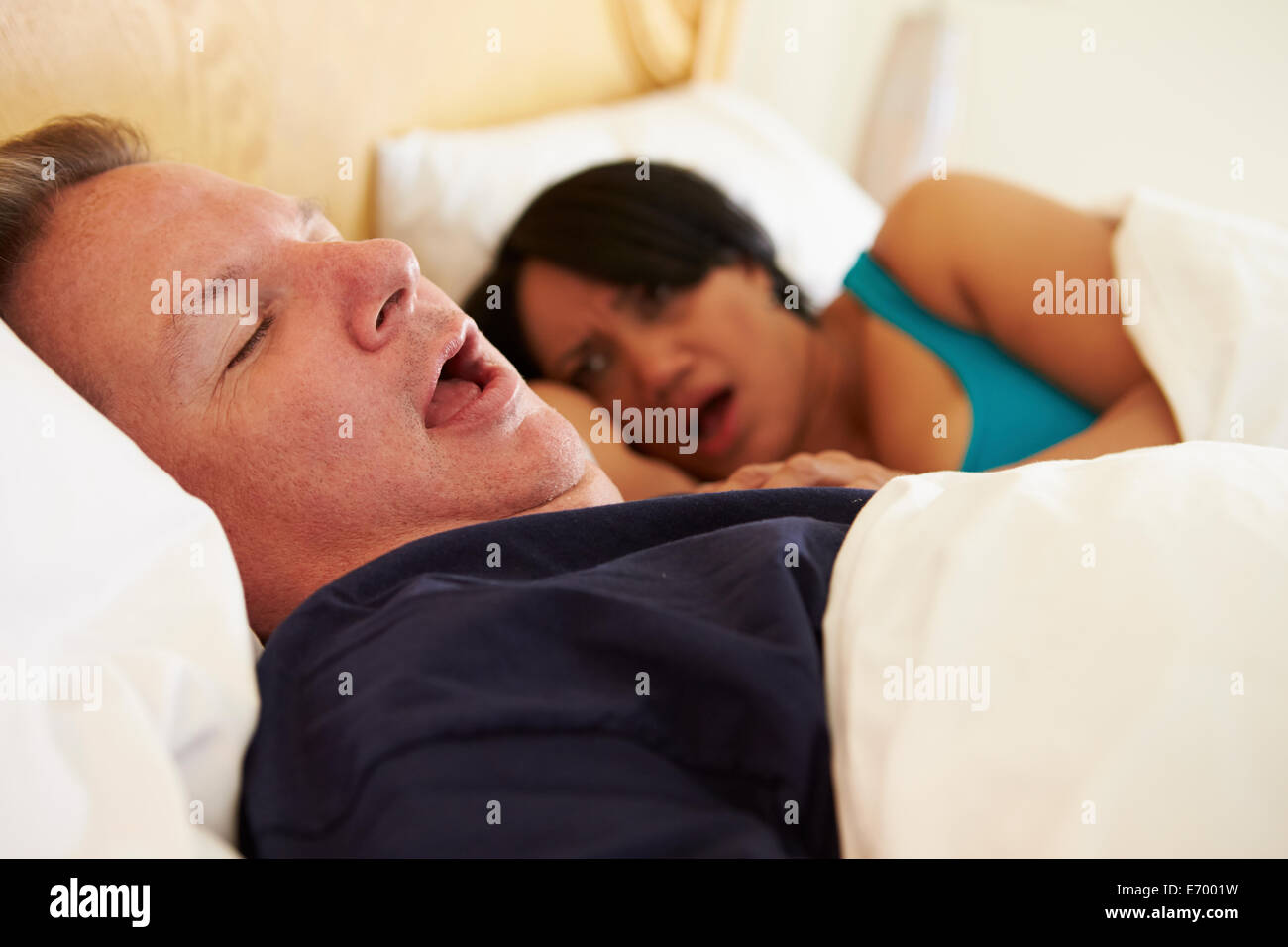 Couple Asleep In Bed With Man Snoring Stock Photo