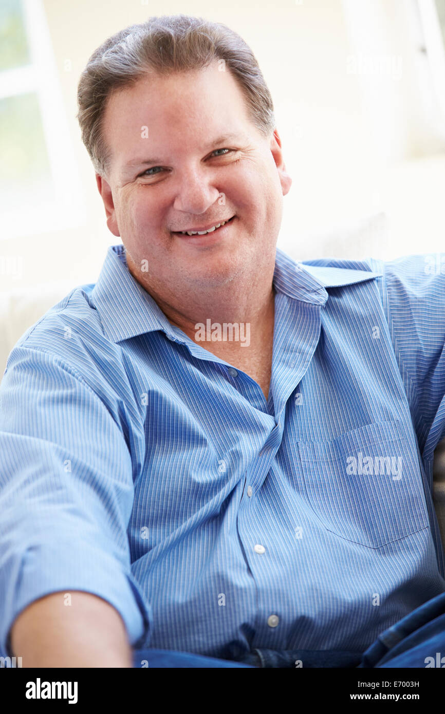 Portrait Of Overweight Man Sitting On Sofa Stock Photo Alamy