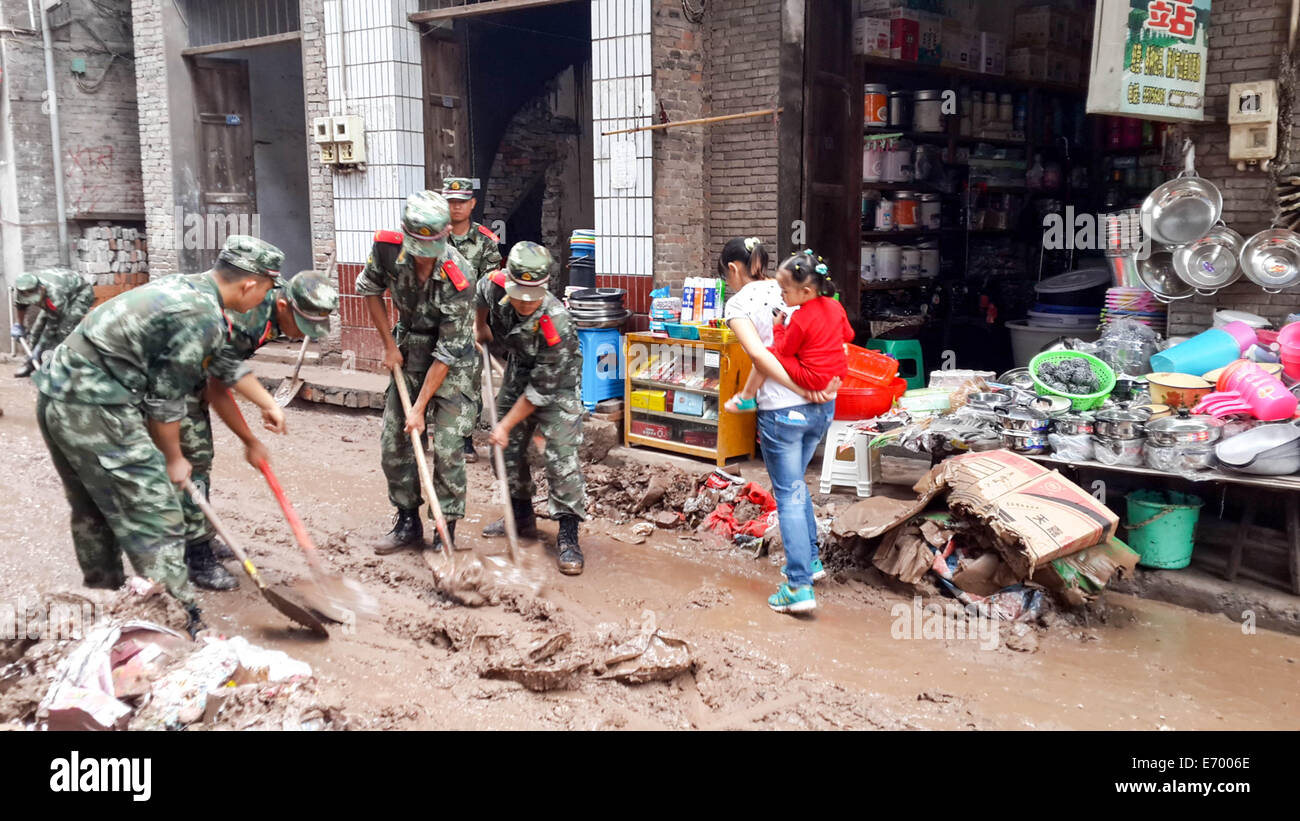 Chongqing, China's Chongqing Municipality. 2nd Sep, 2014. Soldiers help clean muds in Sangping Town of Yunyang County, southwest China's Chongqing Municipality, Sept. 2, 2014. Eleven people died and 27 others were missing as of 3 p.m. Tuesday after rainstorms brought landslides to Chongqing. A total of 1.09 million local residents in 9 counties and regions were affected. Credit:  Xie Jiang/Xinhua/Alamy Live News Stock Photo