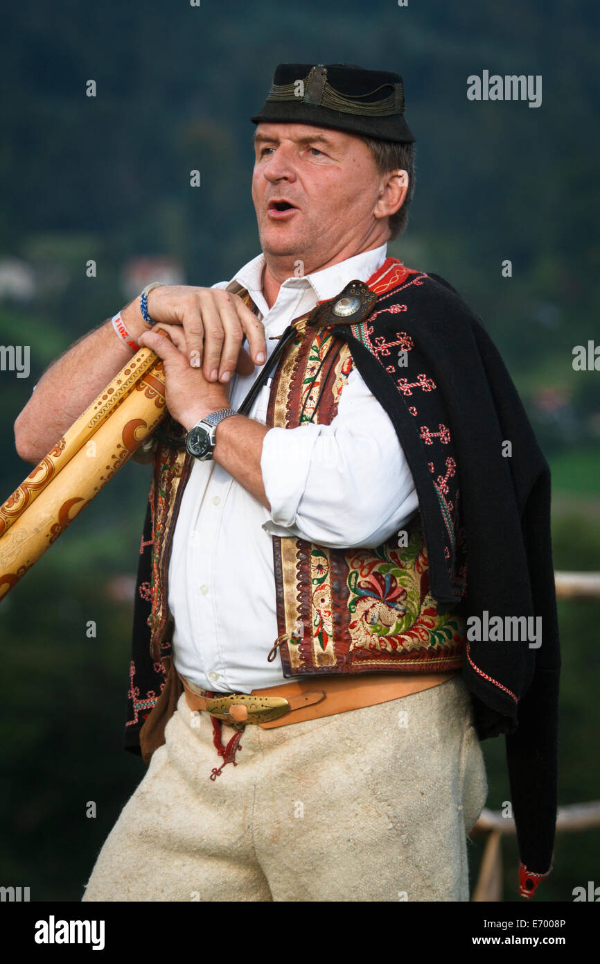 Slovak folk musician in traditional costume singing a pastoral song. He ...