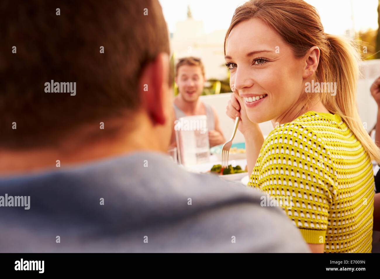Couple Enjoying Outdoor Summer Meal With Friends Stock Photo