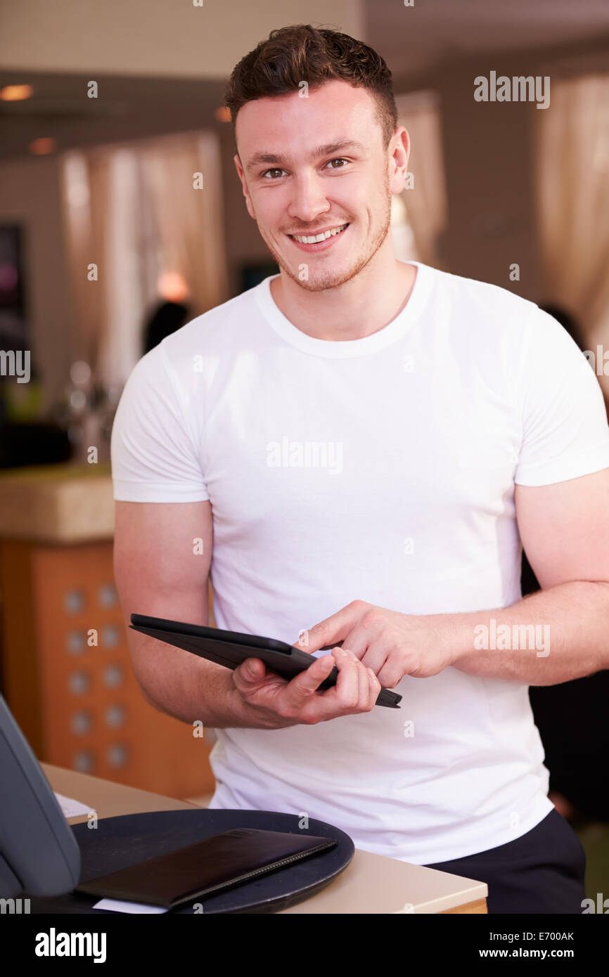 Portrait Of Waiter In Hotel Using Digital Tablet Stock Photo - Alamy