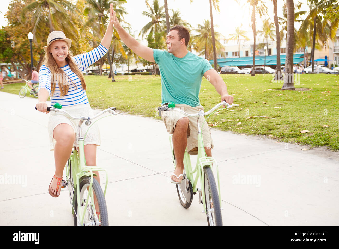 Young Couple Having Fun On Bicycle Ride Stock Photo