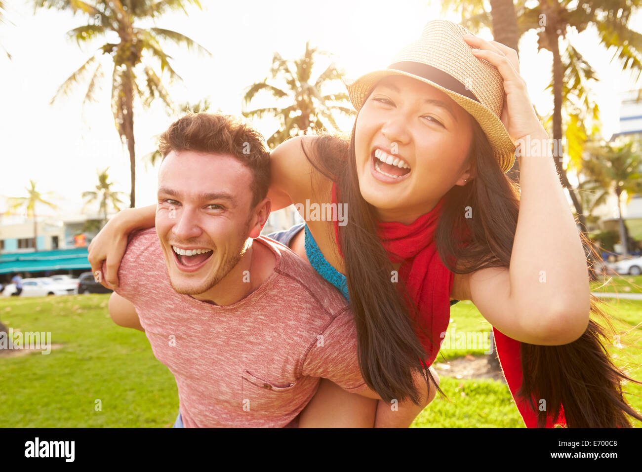 Young Couple Having Fun In Park Together Stock Photo