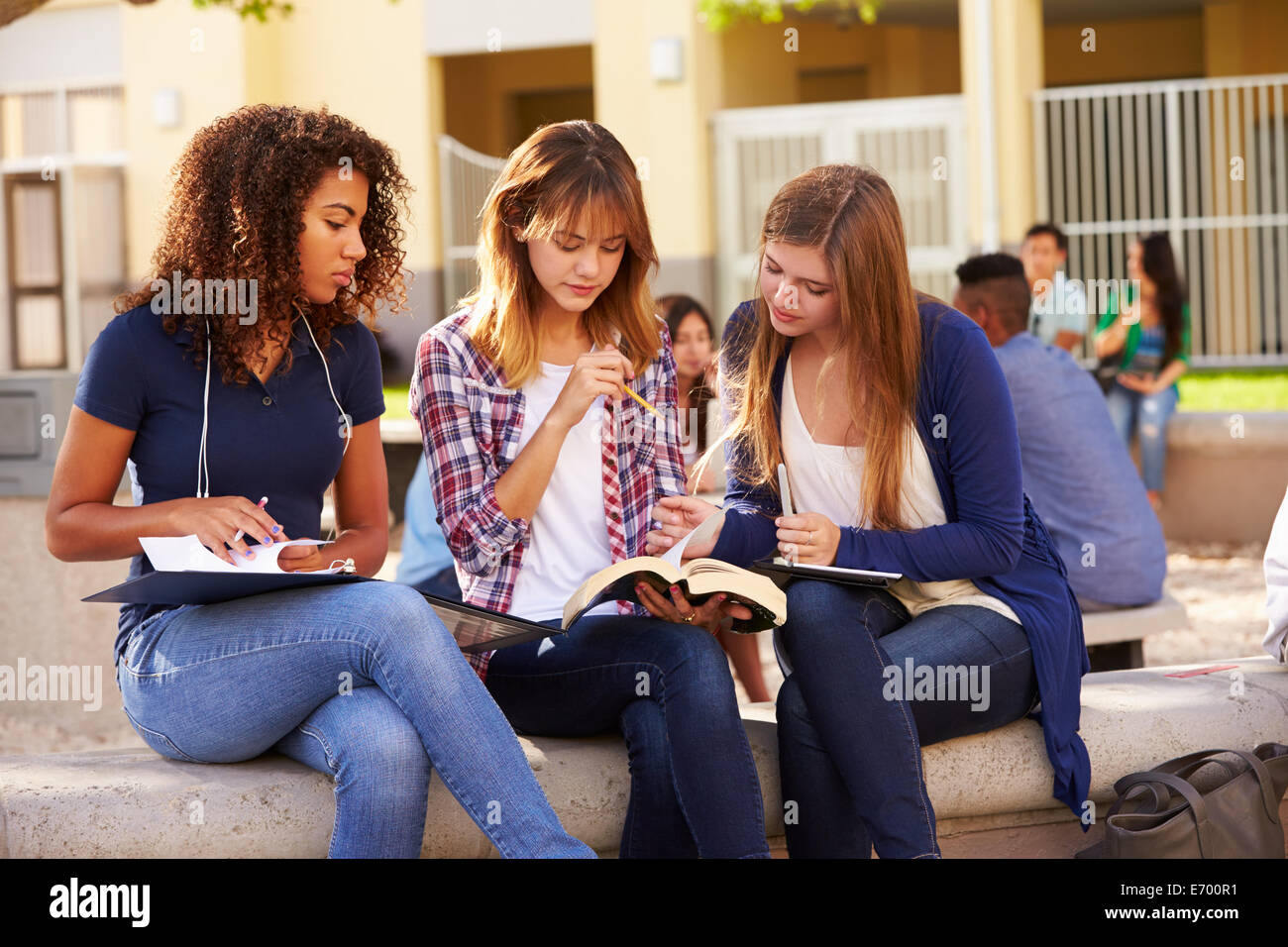 Three Female High School Students Working On Campus Stock Photo
