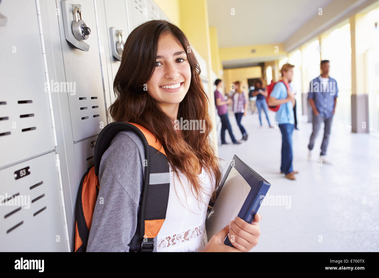 Female High School Student Standing By Lockers Stock Photo
