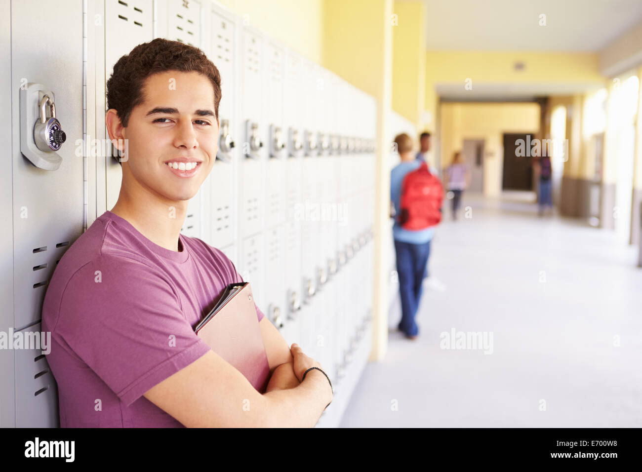 Male High School Student Standing By Lockers Stock Photo