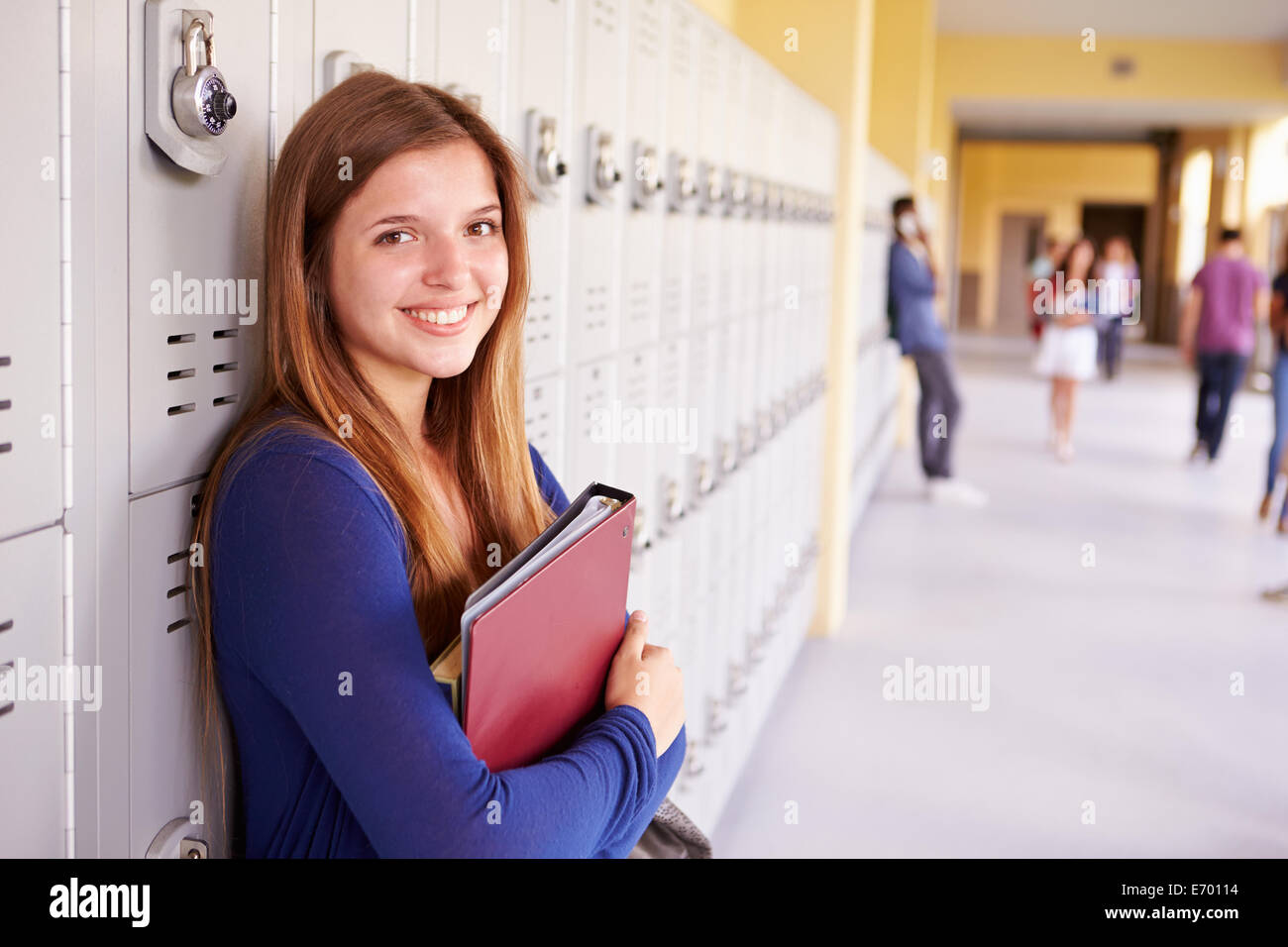 Female High School Student Standing By Lockers Stock Photo