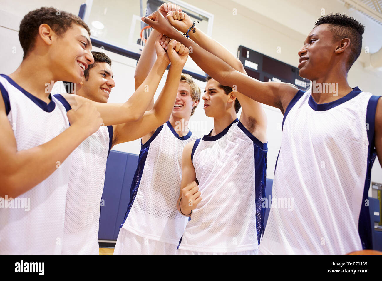 Male High School Basketball Team Having Team Talk With Coach Stock Photo