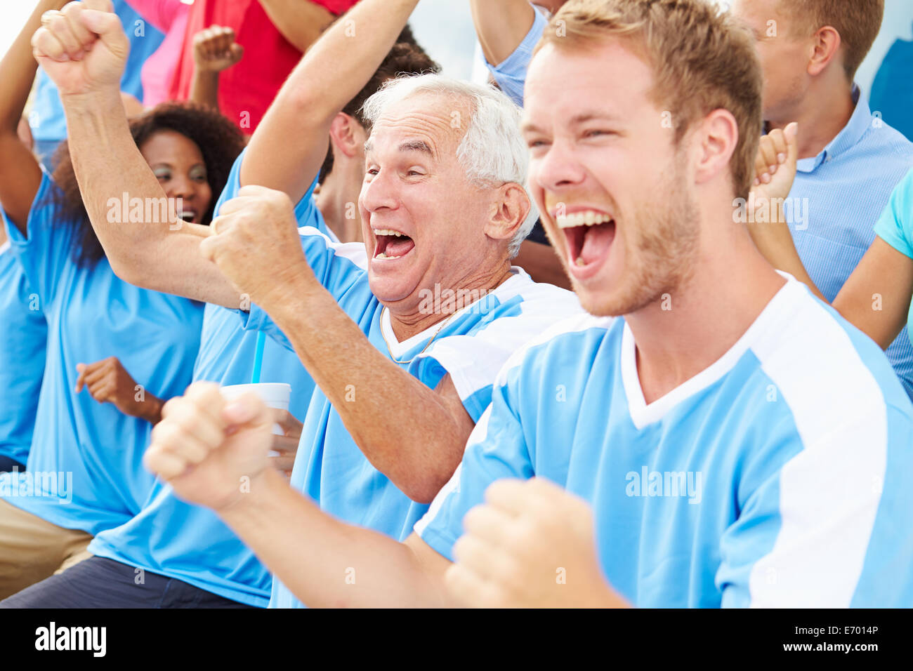 Spectators In Team Colors Watching Sports Event Stock Photo