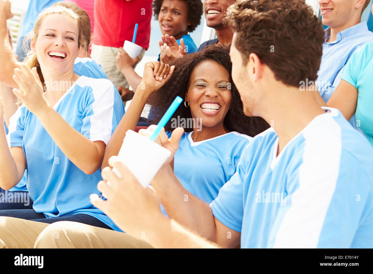 Spectators In Team Colors Watching Sports Event Stock Photo