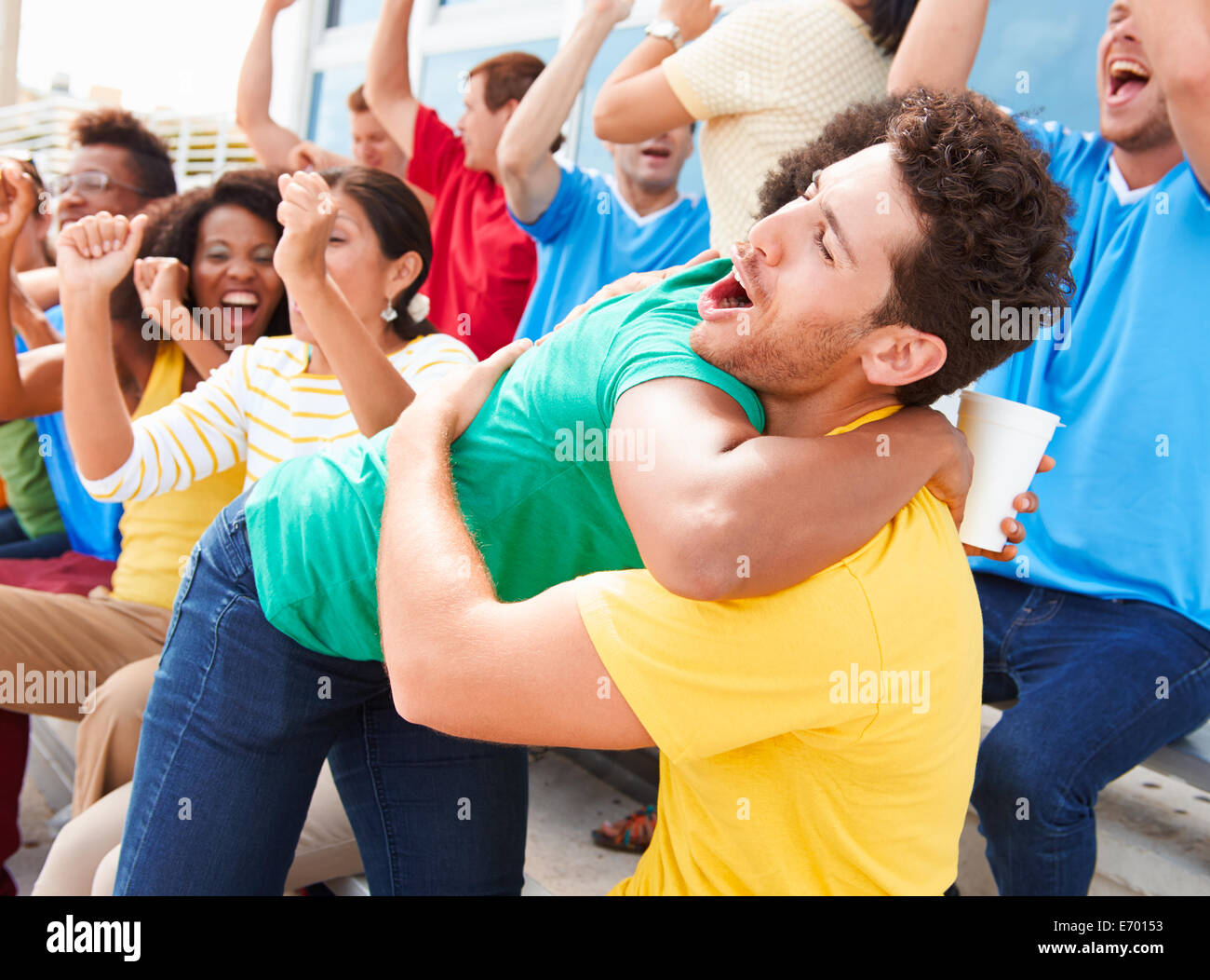 Sports Spectators In Team Colors Celebrating Stock Photo