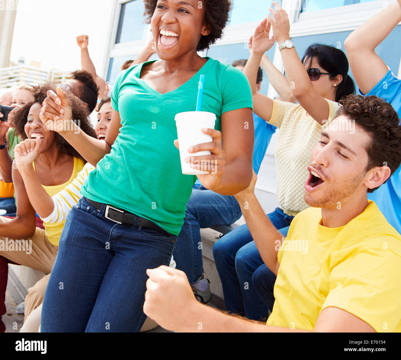 Sports Spectators In Team Colors Celebrating Stock Photo