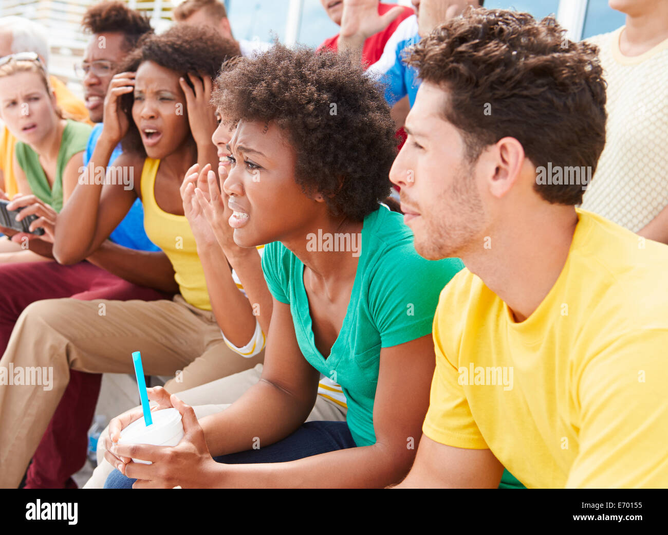 Disappointed Spectators In Team Colors Watching Sports Event Stock Photo