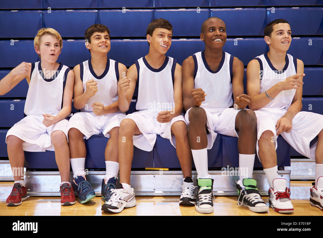 Members Of Male High School Basketball Team Watching Match Stock Photo