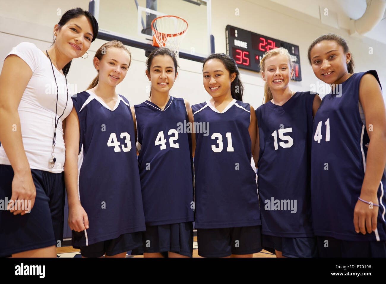 Members Of Female High School Basketball Team With Coach Stock Photo