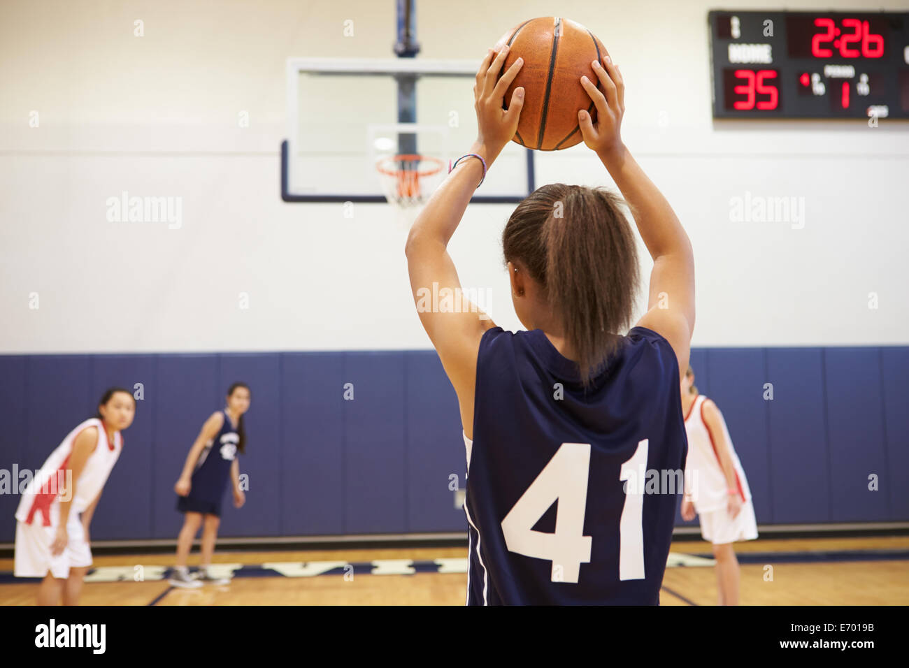 Female High School Basketball Player Shooting Basket Stock Photo