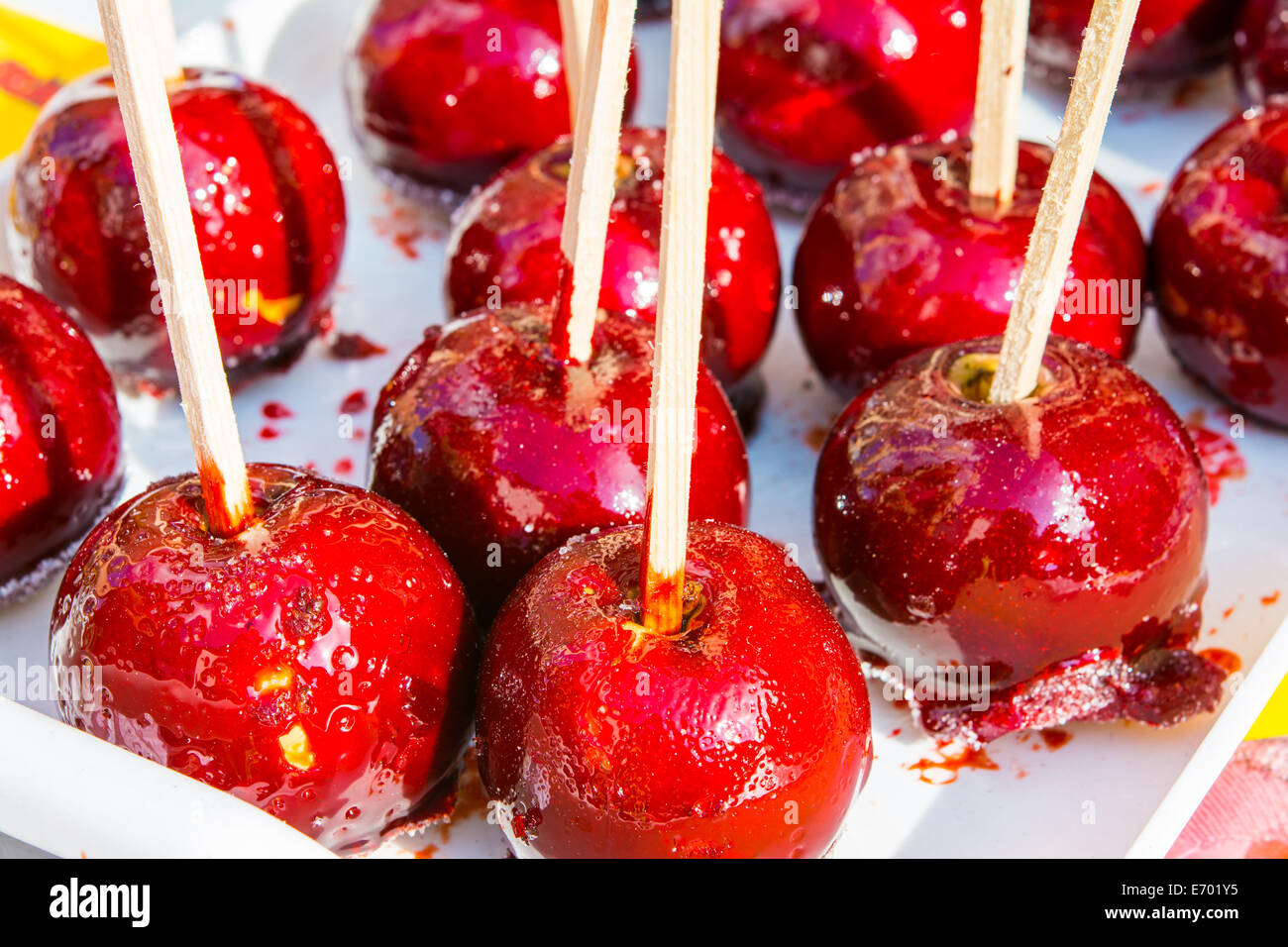 Caramelized Red Apples On White Wooden Sticks Stock Photo